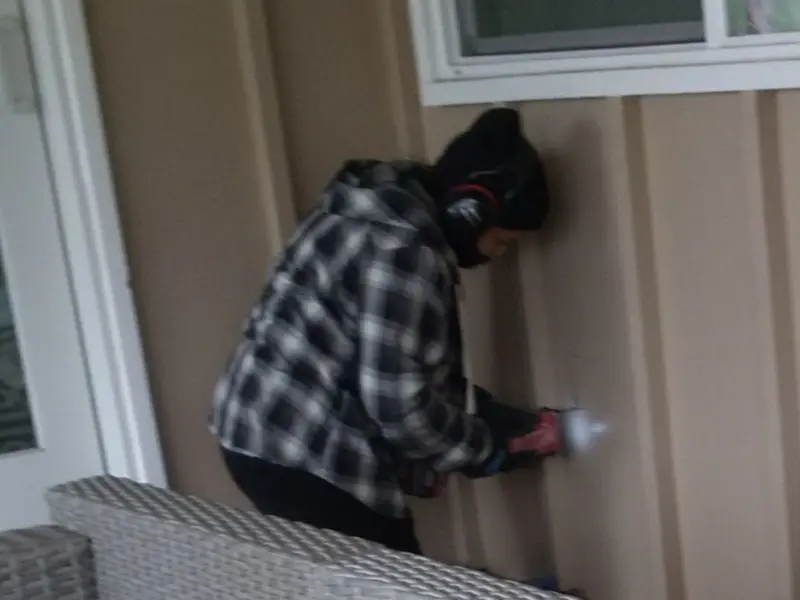 Professional electrician installing an exterior outlet in Patterson