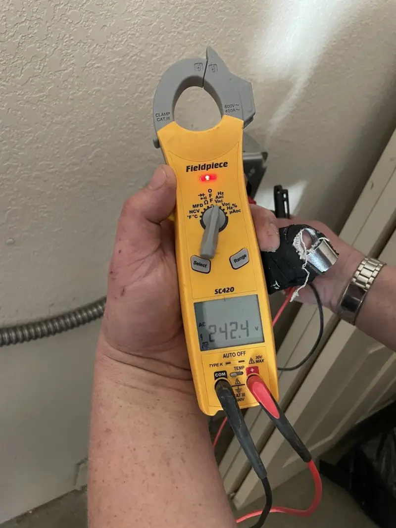 Voltage testing with clamp meter during Outlet Installation in Patterson